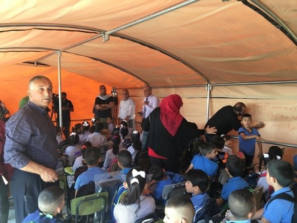 Des enfants et des militants s'entassent dans la tente alors que commence la classe (MEE/Chloé Benoist)